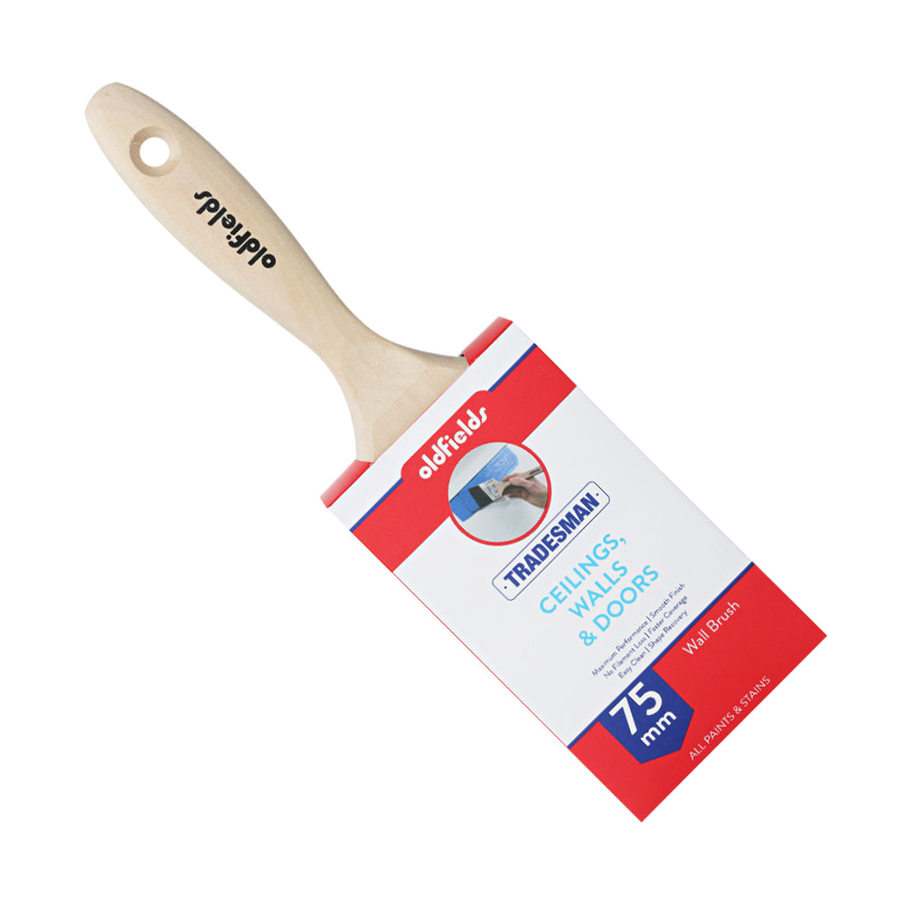 Angled view of Oldfields Tradesman 75mm paint brush with raw birch wood handle and grip