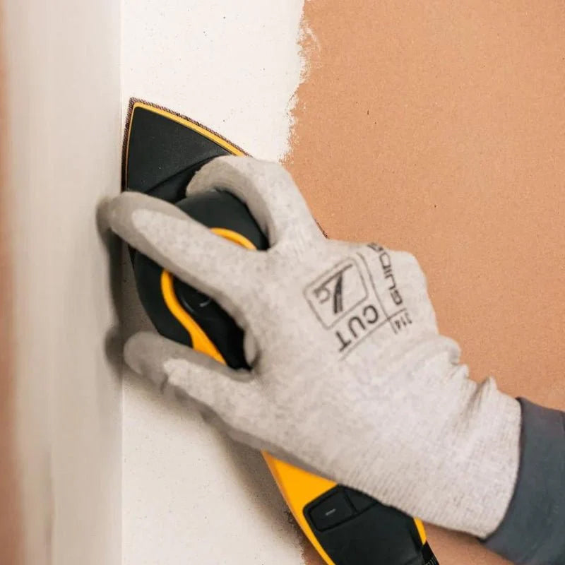 Tradie using Mirka Abranet delta mesh to sand internal plasterboard corners on site