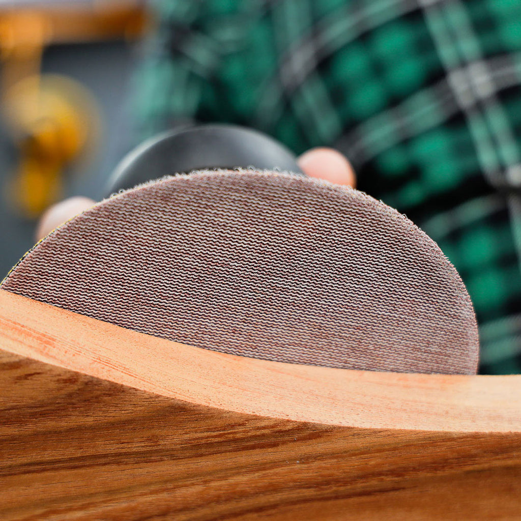 Sanding a curved timber workpiece with a Mirka Abranet Ace ceramic net disc