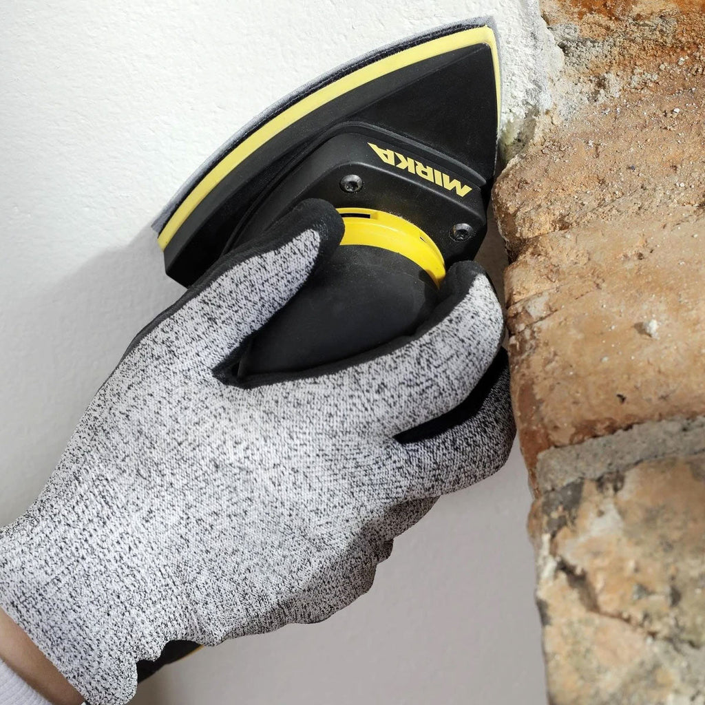 Close-up of Mirka DEOS II Delta sanding a tight corner profile on a timber surface