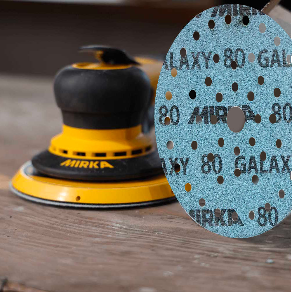 Close-up of a P80 grit Mirka Galaxy 125mm disc showing the self-sharpening ceramic surface