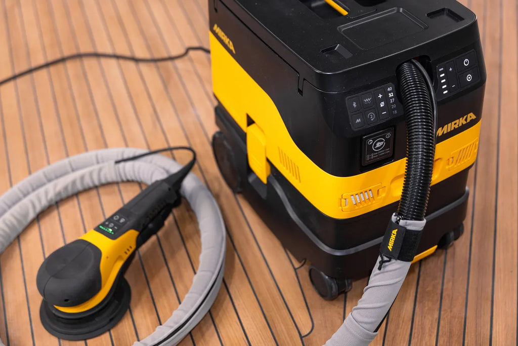Mirka DEROS II connected to a dust extractor using a professional protective sleeve