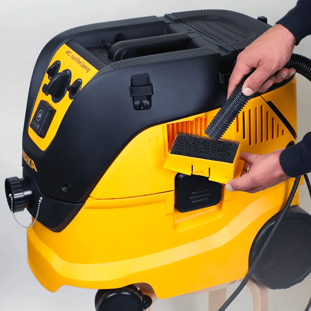 Rear view of the Mirka 1230 M AFC showing integrated power cable storage hooks