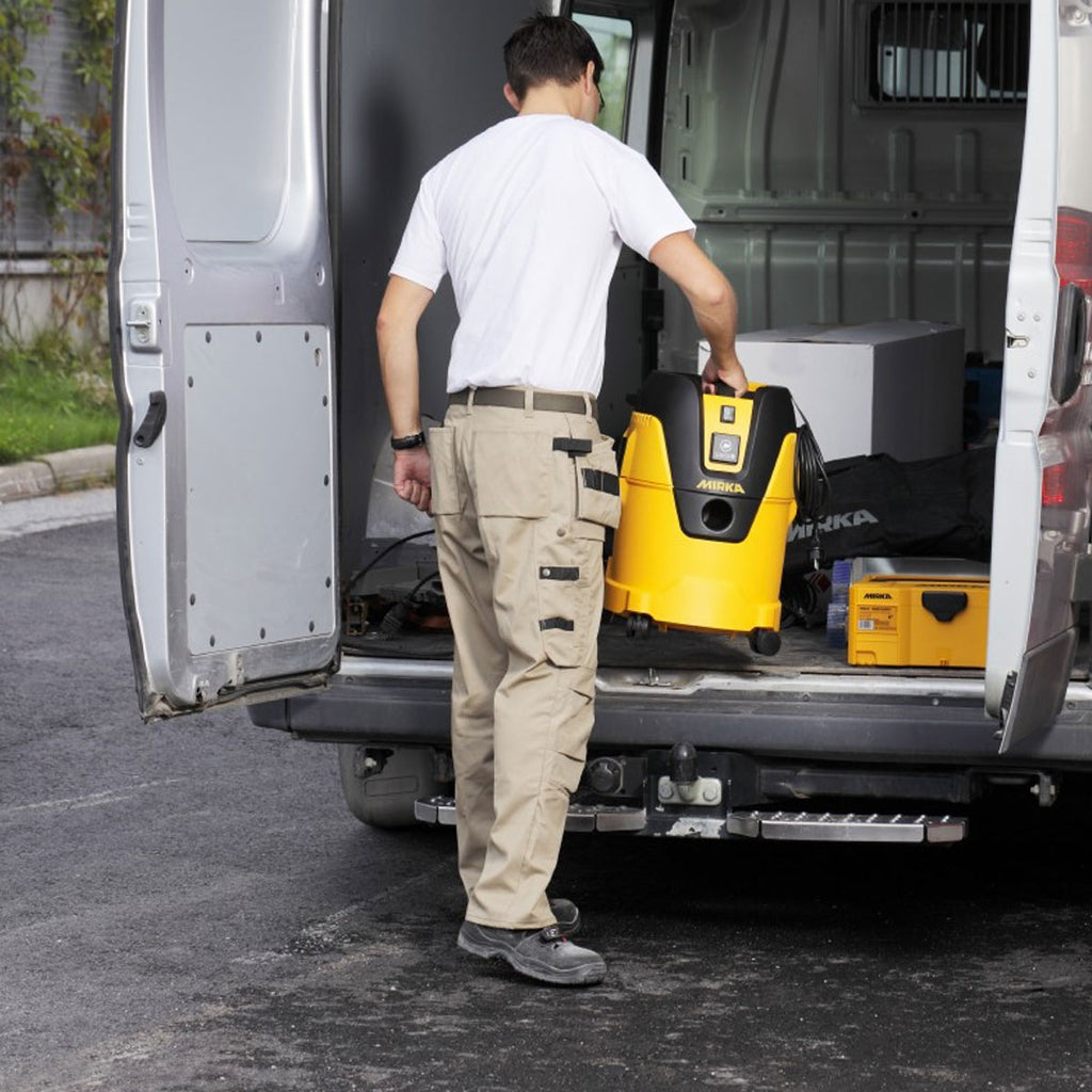Portable Mirka dust extractor being loaded into a tradie's van for mobile site work