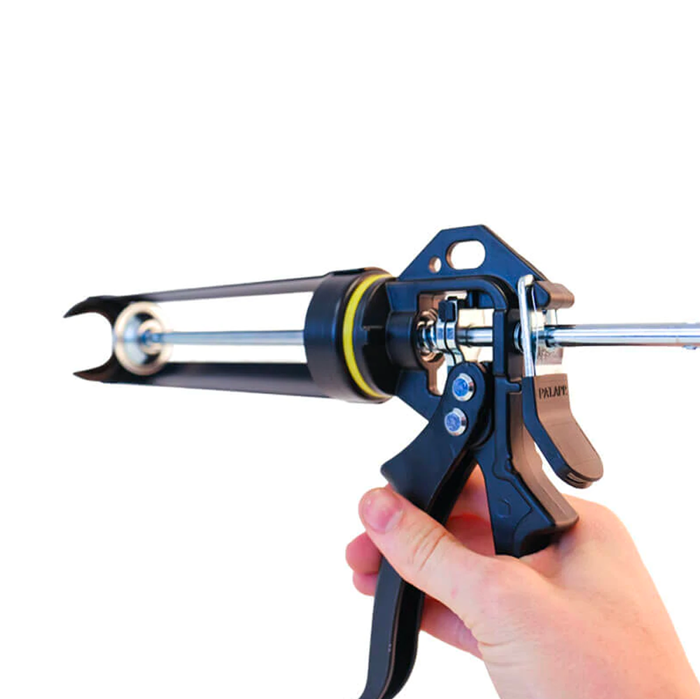 Hand holding the Soudal Dripless HD gun showing the ergonomic large trigger design